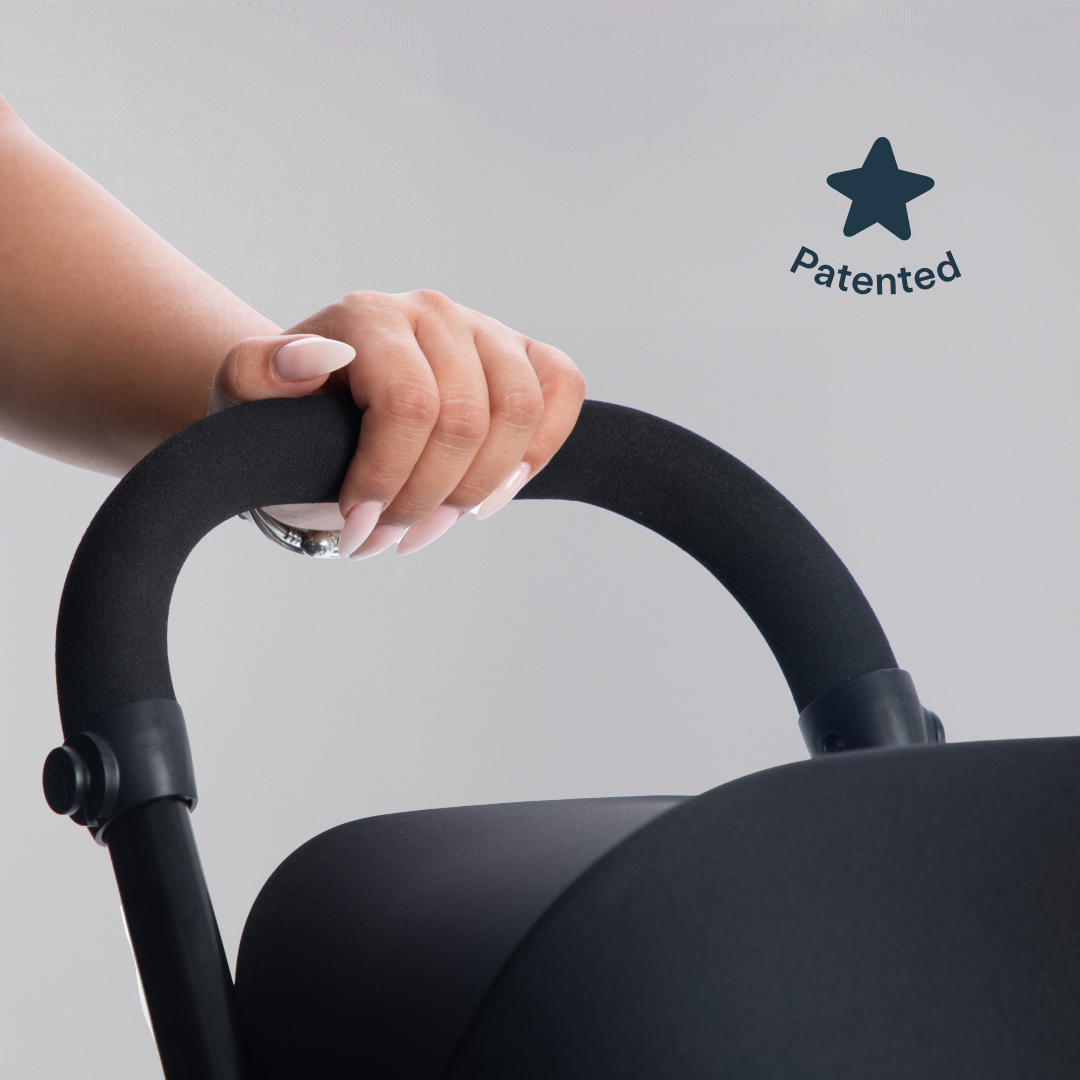 A hand on the parent handle of a smarTrike