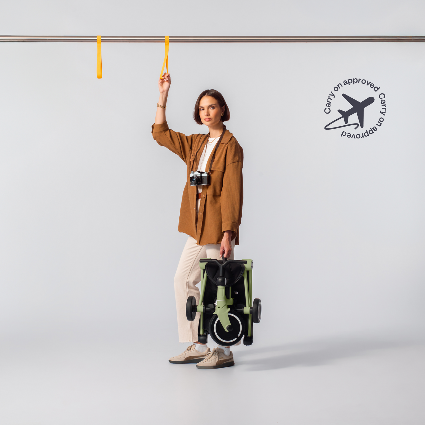 A parent holding a folded Wonder, carry-on approved