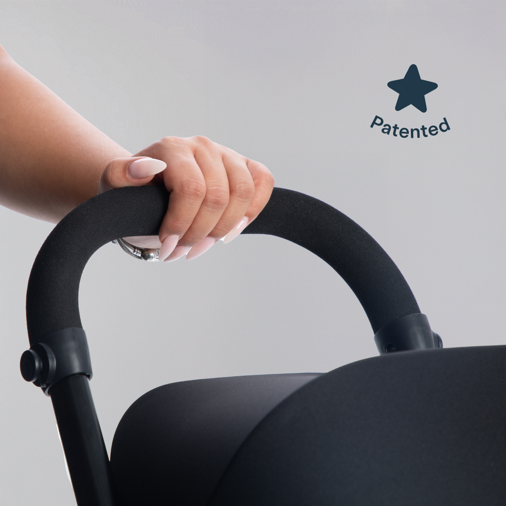 A hand on the parent handle of a smarTrike