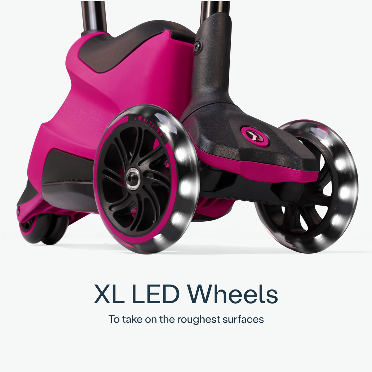 Pink smarTrike Xtend Ride-on scooter with four wheels and steering handle, suitable for young children.