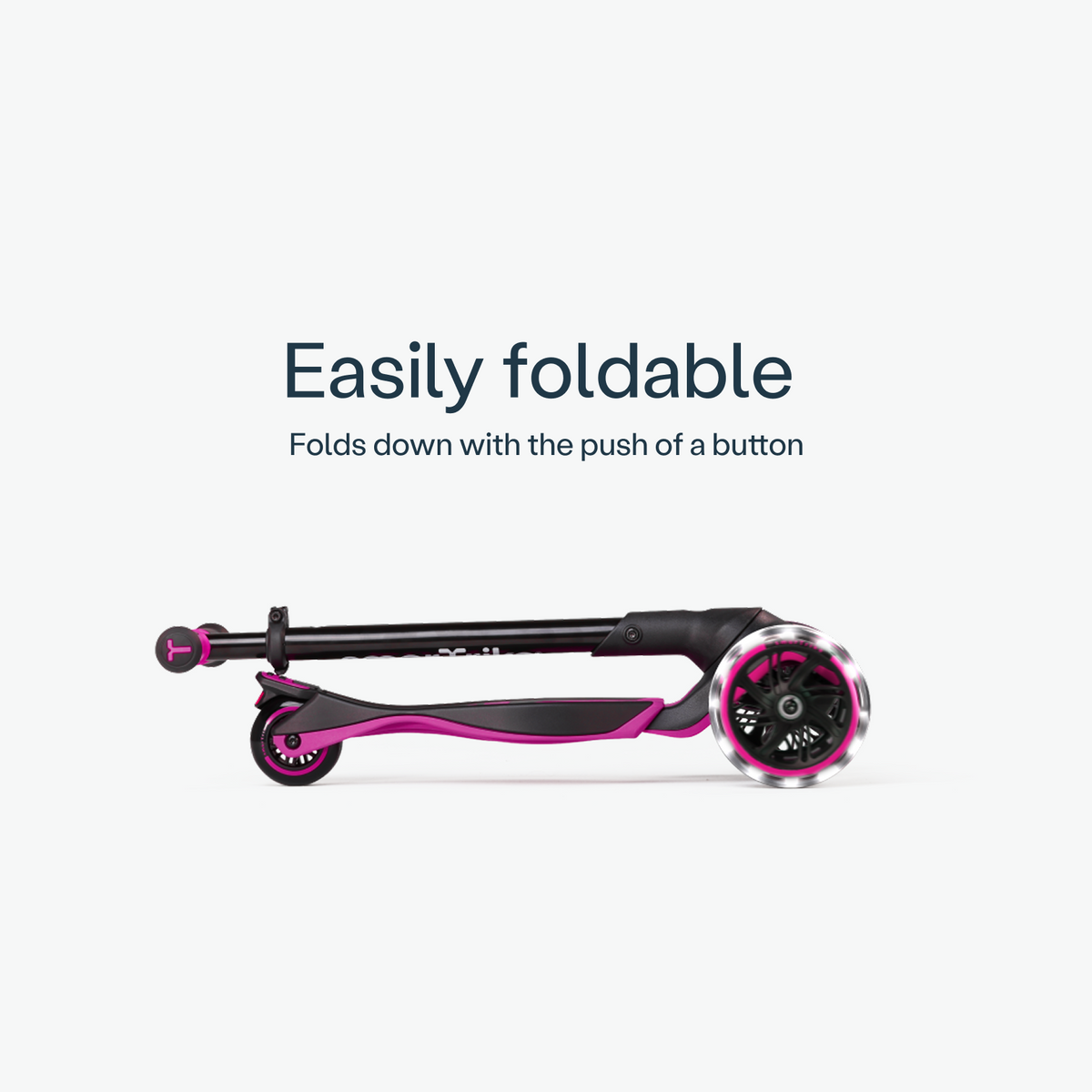 Folded pink smarTrike Xtend Ride-on scooter, compact and portable, ready for storage or transportation.